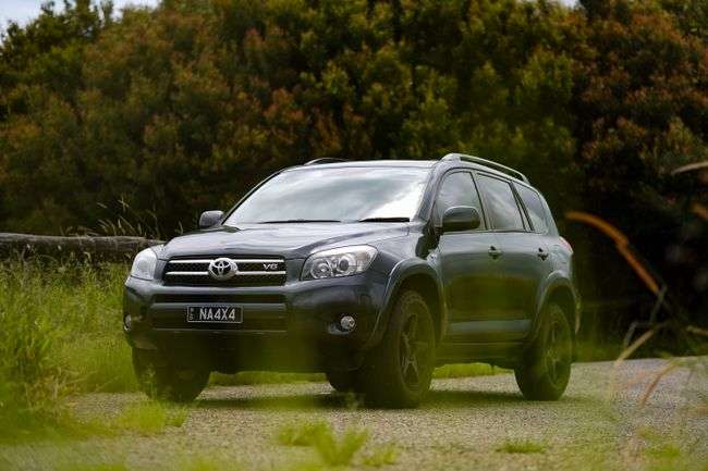 Toyota RAV4 in black parked in a open field