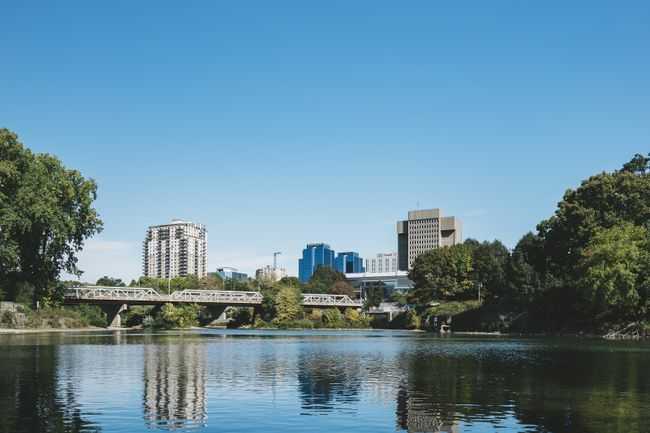Tranquil river view with city skyline of London, Ontario and blue sky