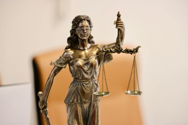 Scales of justice sitting on a desk in a courtroom